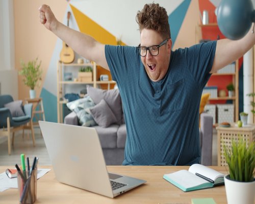 Person stretching arms while sitting at the home office desk